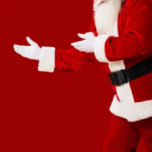 Santa in a red suit in front of a ared background.