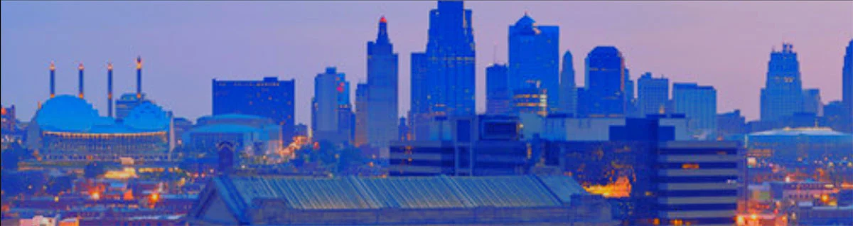 Downtown Kansas City, Mo skyline with a blue and purple hue and roof of Union Station in the foreground.