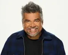 Latino comedian George Lopez in a black jacket and shirt.