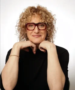 Jewish comedian for hire in a black shirt and glasses.