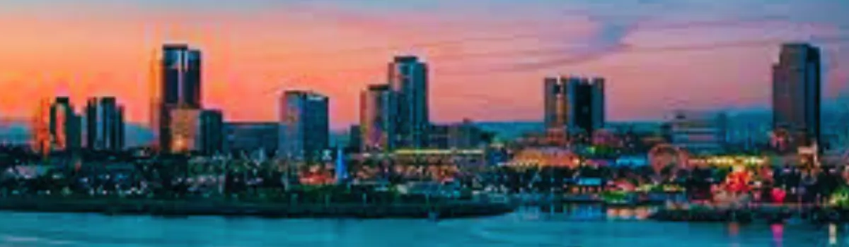 Distorted image of Long Beach skyline at sunset with peach and puruple hues.